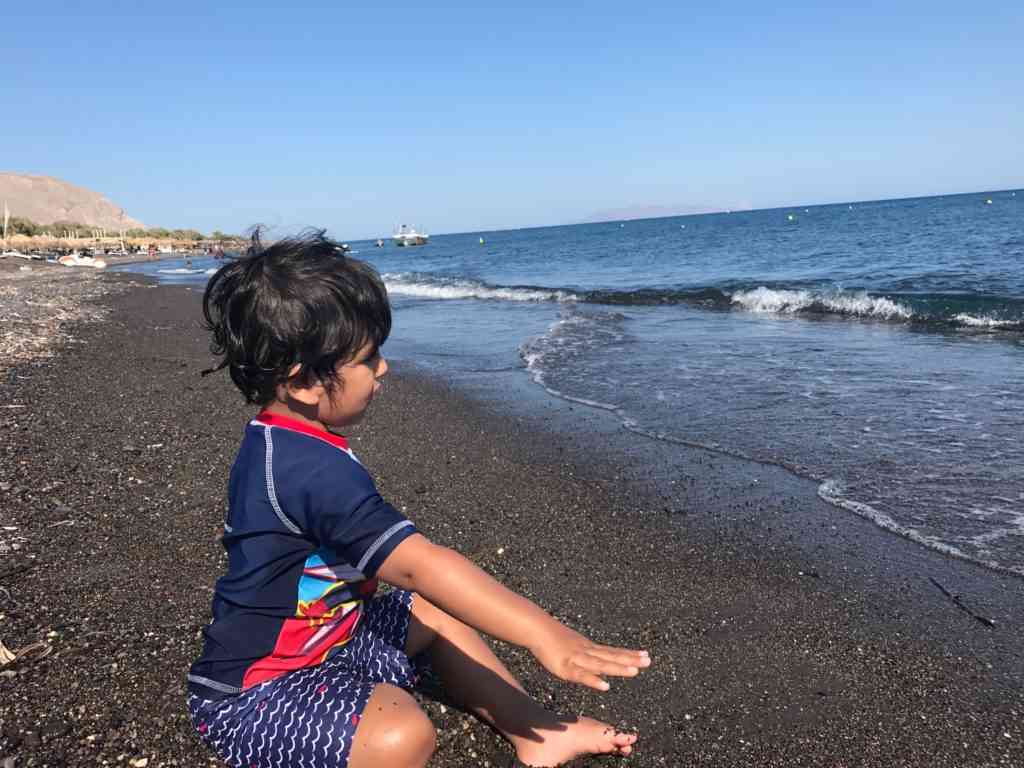 Aarav enjoying the amazing black sand beaches of Santorini